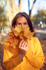 Beautiful caucasian young woman walking and having fun outdoors in autumn time.