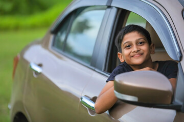 Cute Indian child showing face expression in car