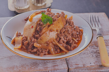Baked potato with minced beef and onion.