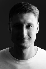 Face of young handsome man in the dark