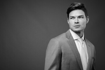 Studio shot of young handsome businessman in suit