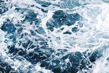 Fototapeta na wymiar Ocean wave background. Bubble water backdrop. Turbulent sea texture. Messy water flow. Depth of the sea. Water foam surface backdrop.