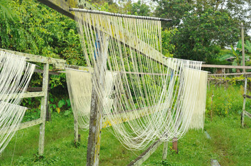 Misua noodles hanging under the sun to dry in the traditional way in Sibu, Sarawak, Malaysia. 