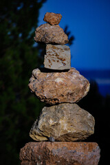 Rock Balancing in the forest with an unfocused background. Stone Balancing