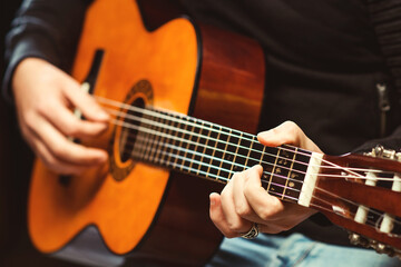 Guitarist holding an acoustic guitar. Practicing in playing guitar. Music concept. Music festival.