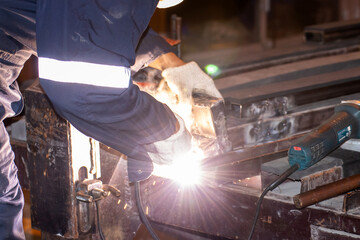 Man working welding steel,male worker metal is part in factory with PPE safety