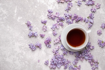 A Cup of tea on a saucer in a frame of flowers.