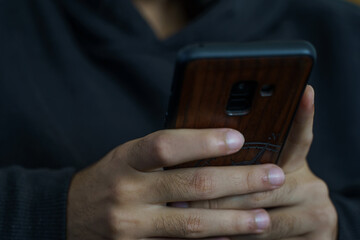 Person using a mobile phone, writing, reading, sending a message, calling