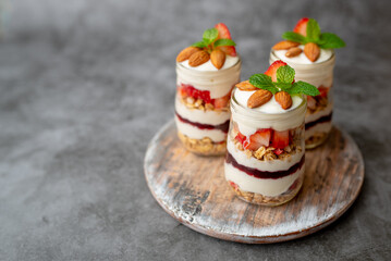 Obraz na płótnie Canvas Strawberry Dessert Jar, yogurt fruit parfait topped with almonds