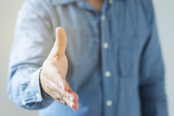 professional businessman hr recruiter consultant extending hand at camera for handshake.