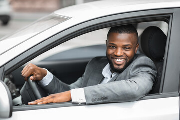 Happy businessman driving home after working day