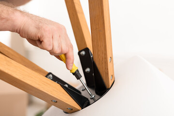 Unrecognizable Man Using Screwdriver Making Table Working Indoor, Closeup, Cropped