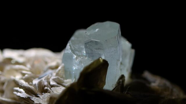 Double crystal of aquamarine detail shot showing the prismatic properties and the octagonal structures merged.  Sample from Argentina.  Muscovite matrix.