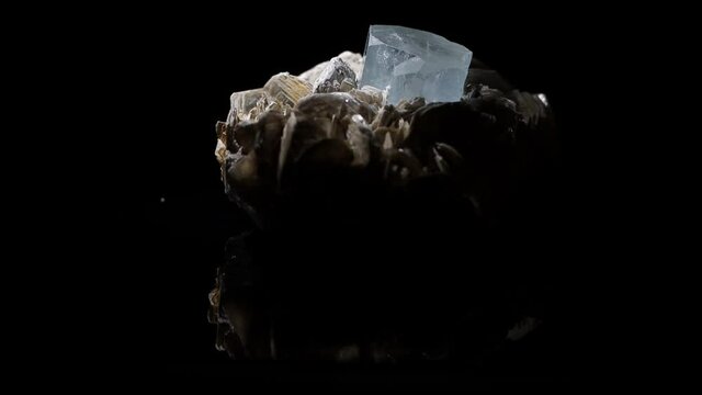A beautifully formed aquamarine crystal emerges from a muscovite matrix. This is a sample found in Argentina.