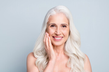 Close-up portrait of her she attractive lovely cheerful grey-haired elderly lady touching cheek...