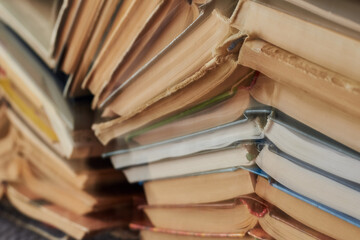Old books piled up in a heap, learning and education concept.