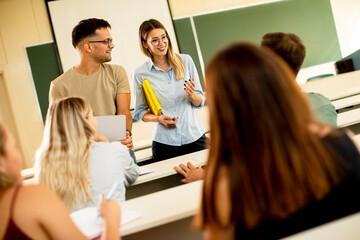 University students in the classroom with young female assistant lecturers