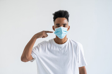 Young african american man in face mask isolated over white background.