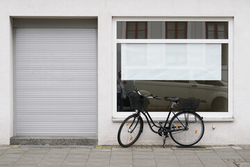 blank vacancy sign or poster with copy space in empty store window with bicycle parked outside...