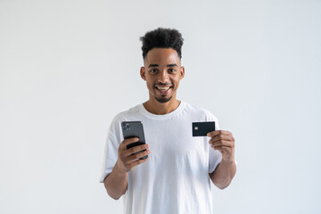 African young man making a payment using his mobile device isolated on white background