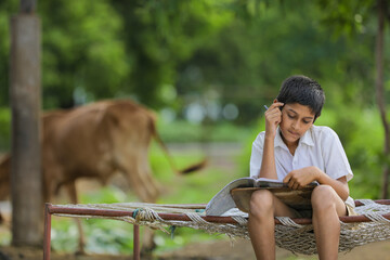 Cute Indian child studying at home.