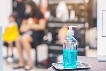 Blue alcohol gel bottle for hands cleaning to prevent the spreading of the Corona virus (Covid-19),Place the entrance service for customers  in the sport store.Healthcare concept.New normal lifestyle.