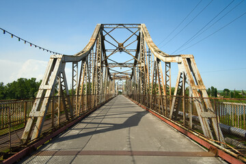 Steel bridge across river. Old rusty iron bridge made for walking. Galich, Ukraine