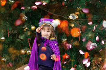 a child dressed as a wizard astrologer makes magic with the help of a candy cane. Christmas miracle.