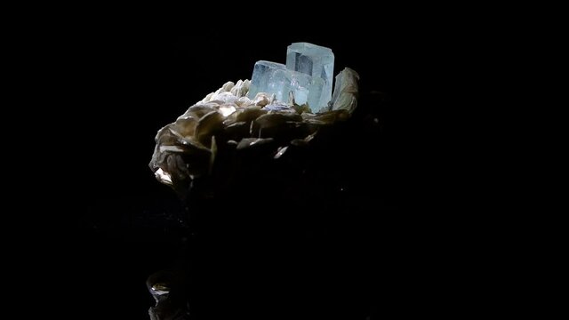 A beautiful double crystal of aquamarine in a matrix of muscovite.  The sample is from Argentina - reflections are from the glass turnstyle.
