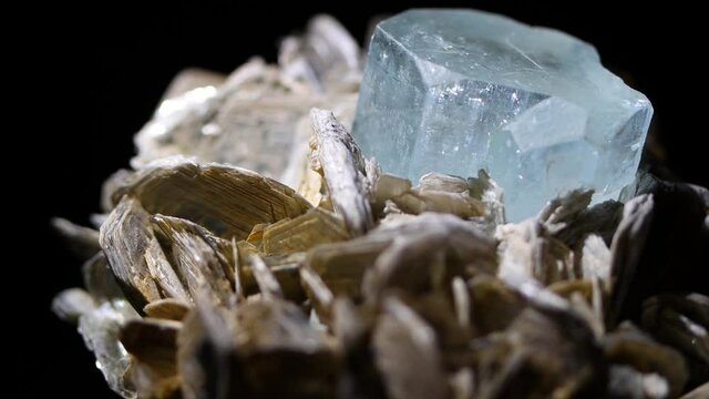 A colorful sample of aquamarine taken from Argentina.  The detailed shot shows the association with the muscovite matrix.