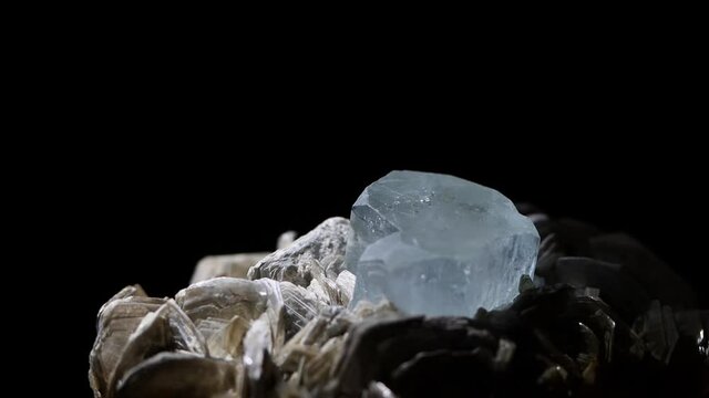 The beauty of an aquamarine crystal up close in a macro shot. The sample sparkles in its matrix of muscovite.