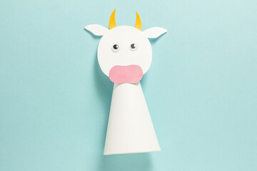 Step-by-step photo instructions on how to make a white bull from paper with your own hands. Symbol of the new year 2021. Simple crafts with children. Step 9. Glue your eyes