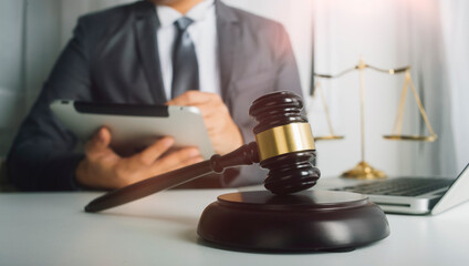 Business and lawyers discussing contract papers with brass scale on desk in office. Law, legal services, advice, justice and law concept picture with film grain effect