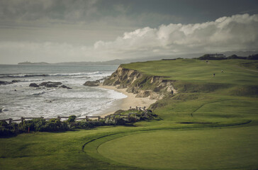 Golf course next to the ocean.