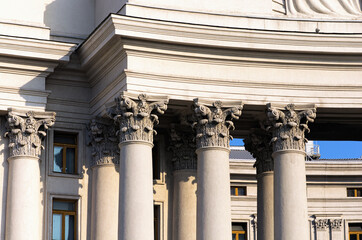 Colonnade with corinthian columns. Detailed view of the top part of column called small capital. Pillars of government. The Building of Ministry of Foreign Affairs of Ukraine. Autumn sunny day