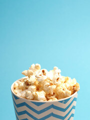 Fresh popcorn on a blue background