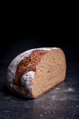 Freshly baked wheat bread, homemade cakes, still life with bread, crisp loaf of bread, still life on a rustic background, rustic style, roll, loaf.
