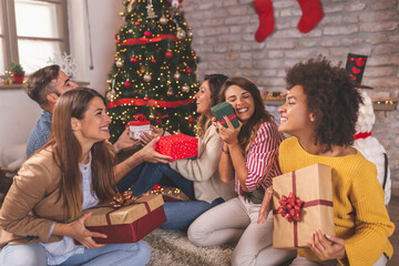 Friends exchanging Christmas gifts
