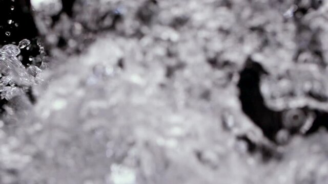 Water pouring in slow motion with splashing liquid on Luma