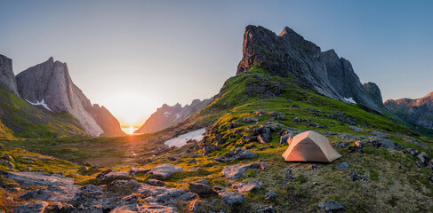 wild camping in the lofoten islands. camping tent among mountains. sunset over camping spot behind polar circle. Panorama of perfect landscape during midnight sun © Jiri