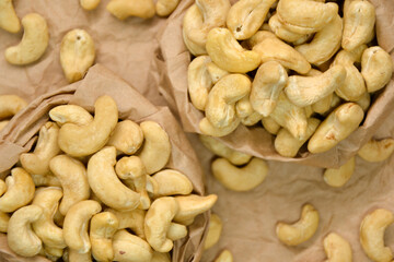 Cashew nuts. Cashew kernels. Clean organic nuts on retro paper background. Organic healthy food.