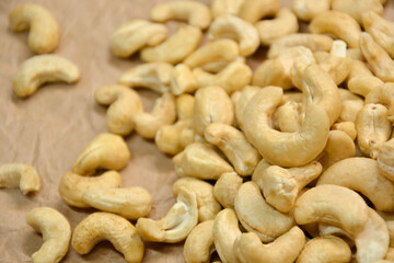 Cashew nuts. Cashew kernels. Clean organic nuts on retro paper background. Organic healthy food.