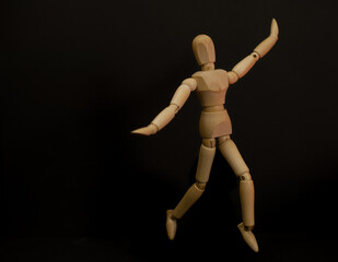 Wooden man in an unusual pose