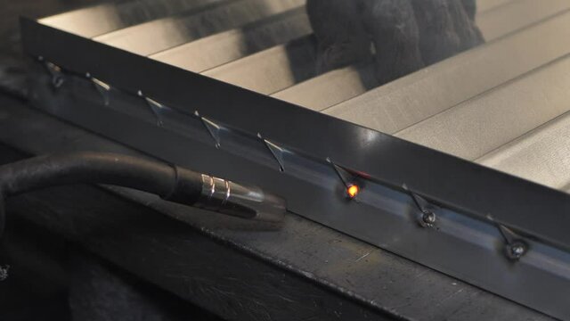 Close-up work with metal steel and iron using a welding machine