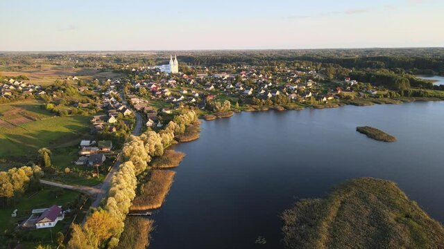 Drone shooting. View from the top of the city by the lake at sunset.
