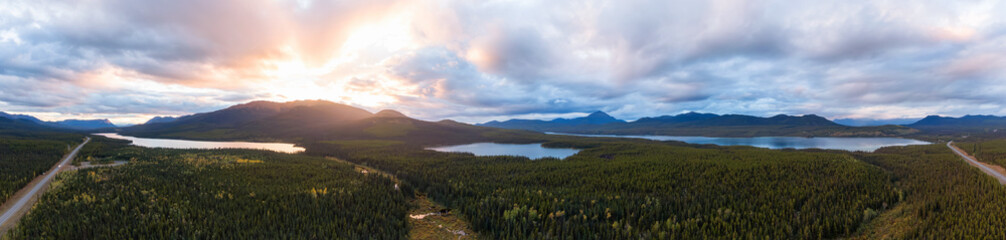 Panoramic View of Scenic Lakes surrounded my Mountains and Forest at Sunset in Canadian Nature. Aerial Drone Shot. Yukon, Canada.