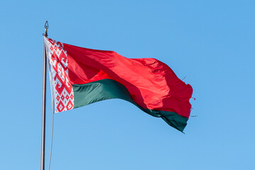 Flag of Belarus waving against blue sky