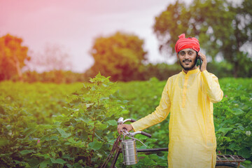 Young indian farmer or labor talking on mobile phone