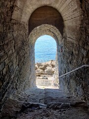a narrow passage leading to the blue waters of the sea