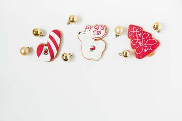 new year and christmas gingerbread cookies and christmas toys. tree shaped. top view. white background. minimalist style.